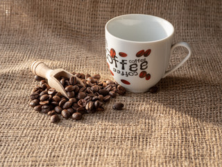 cup of coffee and beans on burlap sack