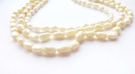 Natural river pearl beads on a gentle pearl necklace on a white background. Close up photography