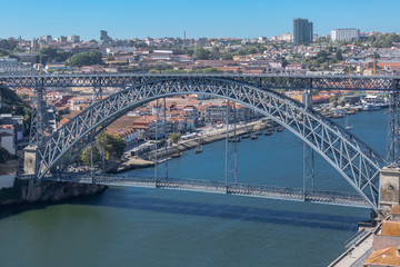 View of D. Luis bridge, Douro river with boats and Gaia city as background