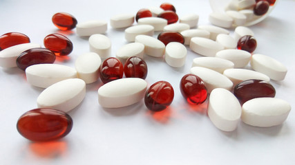 Assorted colorful pharmaceutical medicine pills, tablets and capsules on white background. Pharmacy theme, health care, drug prescription for treatment medication and pharmaceutical medicament