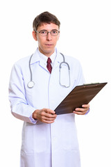 Studio shot of man doctor holding clipboard