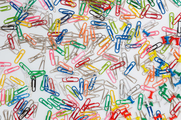 Fototapeta na wymiar A colorful paper clips on a white background, top view.