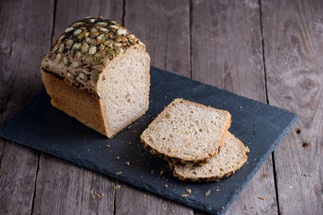 Healthy gluten free bread with seeds and nuts on wooden background