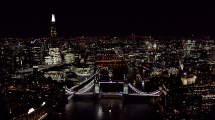 Fototapeta na wymiar Beautiful Panoramic Night Aerial View of New London Cityscape and Landmarks around Tower Bridge and Thames River feat. Famous Skyscrapers