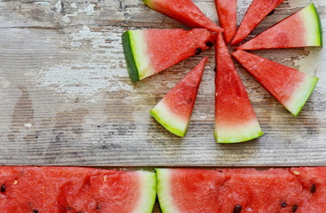 slices of watermelon on a wooden table.
