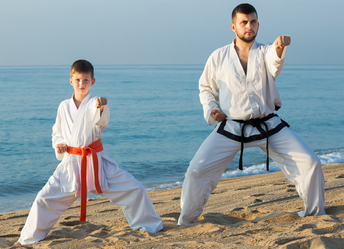 Teacher and pupil doing karate