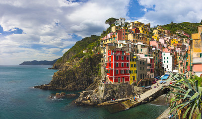 Fototapeta na wymiar beach streets and colorful houses on the hill in Riomaggiore in Cinque Terre in Italy 