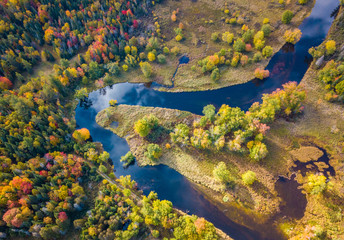 Low level aerial photograph featuring fall foliage in the Adirondack Park of New York State...