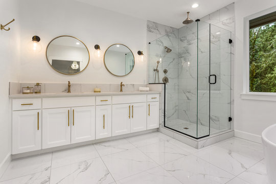 Bathroom in New Luxury Home: Master Ensuite Bathroom with Two Sinks and Shower. Features Elegant Tile Floor