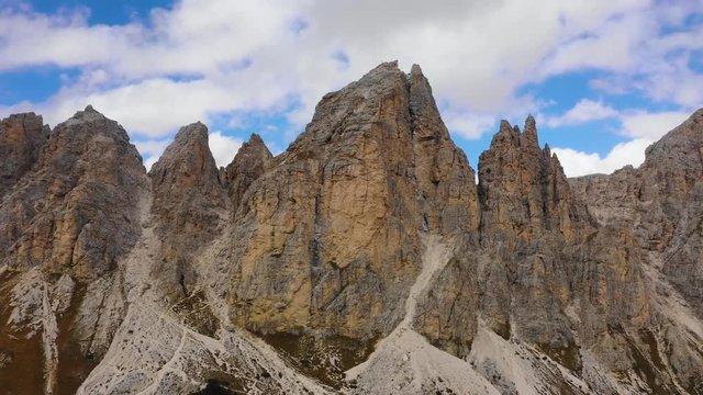 Aerial view of the Paso Gardena Pass in the province of Bolzano. Dolomites. Flying near the Pizes de Cir. In the distant view of a mountain Schelrn. Autumn in Italy