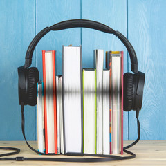 headphone and books on blue background