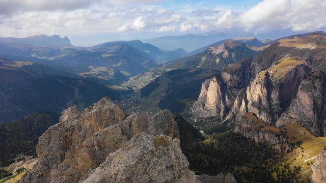 Aerial view of the Paso Gardena Pass in the province of Bolzano. Dolomites. Flying near the Pizes de Cir. In the distant view of a mountain Schelrn. Autumn in Italy
