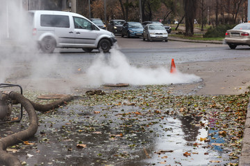 Odessa, Ukraine- Nov. 28, 2018: Accident on heating main. Burst pipes with hot water. Winter cold...