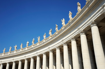 Fototapeta na wymiar Statues in St. Peter Square (Rome, Italy) with blue sky background
