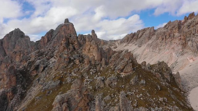 Aerial view of the Paso Gardena Pass in the province of Bolzano. Dolomites. Flying near the Pizes de Cir. In the distant view of a mountain Schelrn. Autumn in Italy