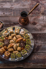 Arabian sweets and delights with coffee on rustic table