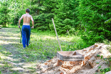 young man carries a truck working in nature