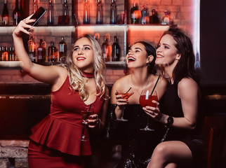 Cheerful female friends resting in the nightclub