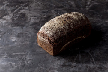 Rye bread on dark board background