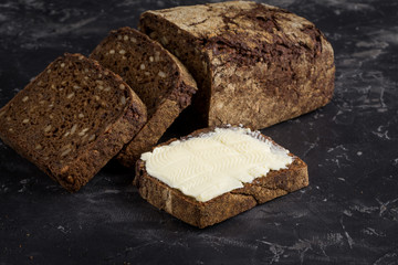 Rye bread on dark board background