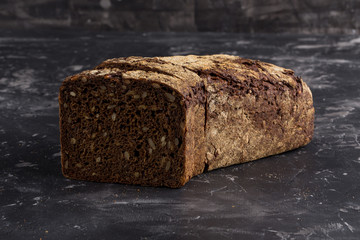 Rye bread on dark board background
