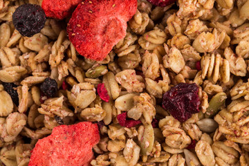 Muesli oat cereals close up background with dry fruits