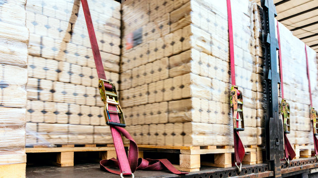  There is a loading to the truck trailer .  fastening of freight in the trailer .   transportation of freight Europe . industrial infrastructure . to fix freight .  Cargo container . 