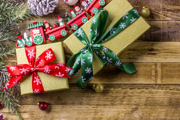 Christmas background with decorations and gift boxes on wooden background. Top view