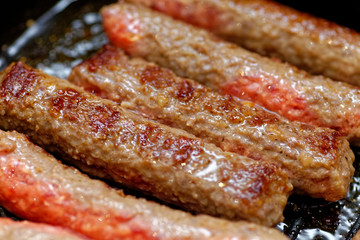 Close up grilled homemade meat sausages. Shallow depth a field