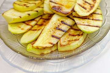 Close up grilled zucchini on plate. Macro of a vegetable. Shallow depth a field