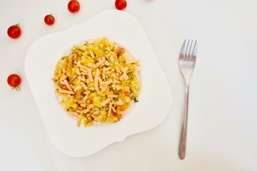 Tasty corn macaroni on the white plate on the white background