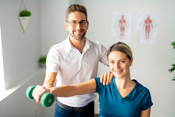 A Modern rehabilitation physiotherapy man at work with woman client
