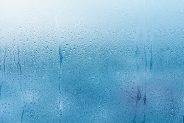 Condensation on the clear glass window. Water drops. Rain. Abstract background texture