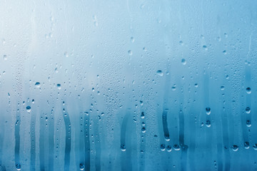 Condensation on the clear glass window. Water drops. Rain. Abstract background texture