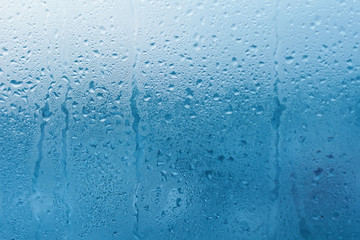 Condensation on the clear glass window. Water drops. Rain. Abstract background texture