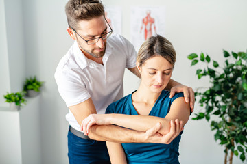 A Modern rehabilitation physiotherapy man at work with woman client