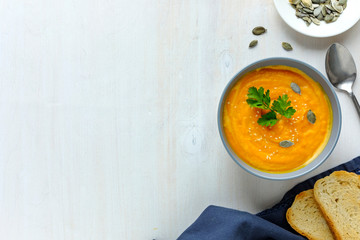 Bowl of pumpkin soup served with seeds