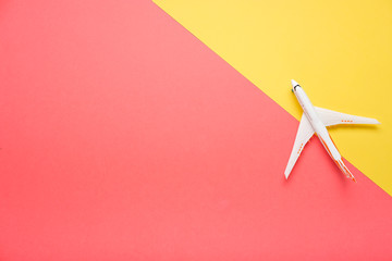 Top view of an airplane on trendy pink background.  Bright summer color. Travel concept.