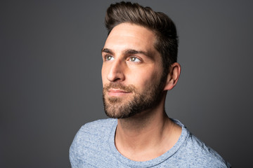 A Handsome man standing over dark grey background Portrait man concept.