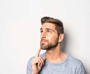 A nice guy in studio white, pointing something