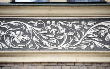Decorative ornamental frieze with 19th century graffito in Prague, Czech.