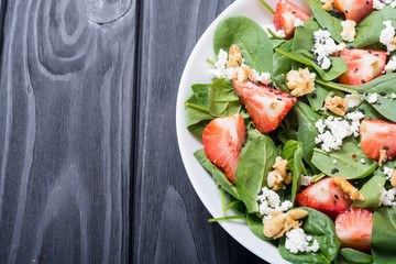 Strawberry salad with spinach , cheese and walnut . Healthy food