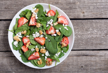 Strawberry salad with spinach , cheese and walnut . Healthy food