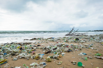 Garbage on beach, environmental pollution in Bali Indonesia. Drops of water are on camera lens. Dramatic view