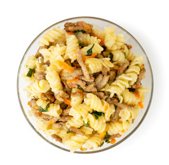 Pasta with minced meat in a glass plate on a white. The view from the top.
