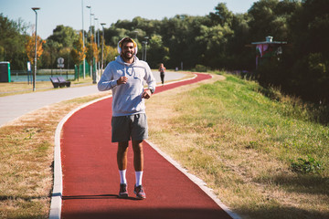 Man running at track in morning time