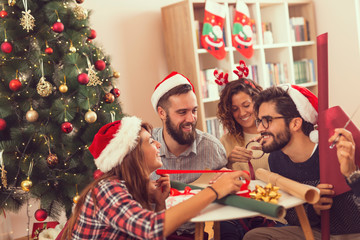 Friends wrapping Christmas presents