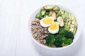 Buddha bowl with quinoa , eggs , avocado , brussels sprouts and broccoli