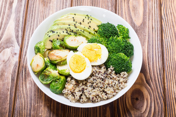 Buddha bowl with quinoa , eggs , avocado , brussels sprouts and broccoli