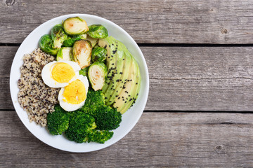 Buddha bowl with quinoa , eggs , avocado , brussels sprouts and broccoli